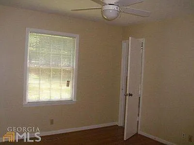 Bedroom #1 window to front yard, door to bathroom and ceiling fan