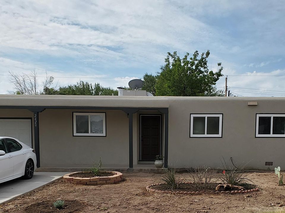 Front of house before landscaped and without plants in bloom