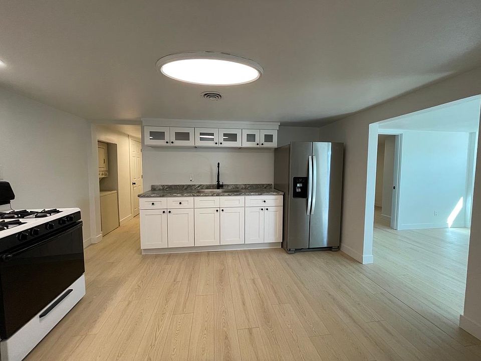 View from the entryway door. Living room and 1st bedroom on right. Left hall leads to bathroom and 2nd bedroom.