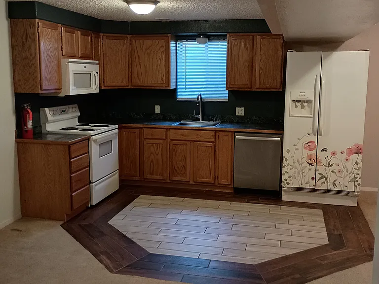 Downstairs full kitchen with tiled flooring
