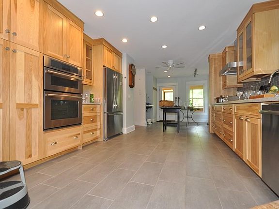Kitchen with back entrance beyond
