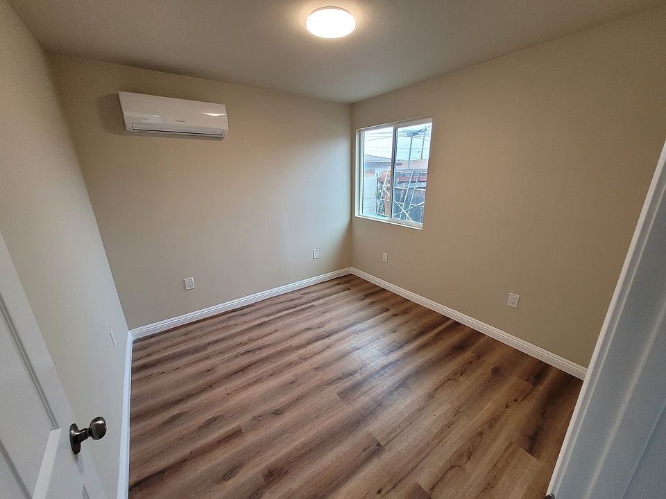 Bedroom with mini-split air conditioner and closet