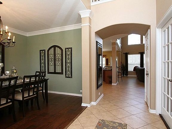 Foyer entering into the formal dining and transitioning to kitchen and living area