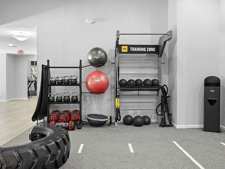 TRX training zone with kettlebells, medicine balls and battle ropes for functional workouts