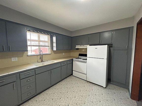 Large kitchen, counterspace and cabinets.