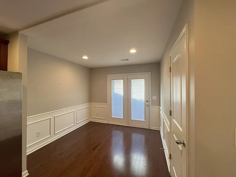 Backdoors open to fenced patio