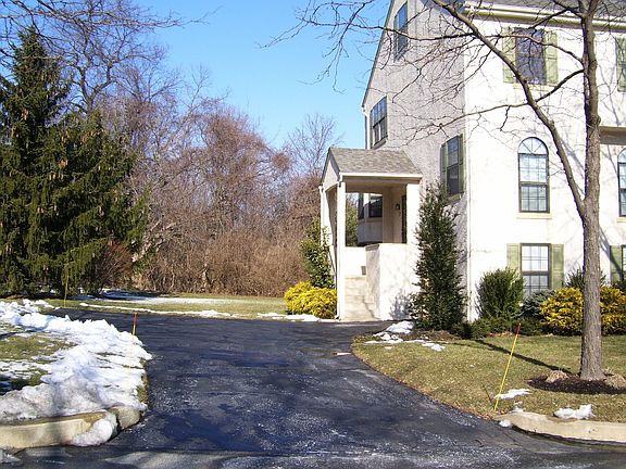Driveway and wooded rear