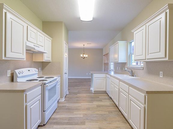 The kitchen has a recently installed dishwasher and plenty of cabinet and counter space.