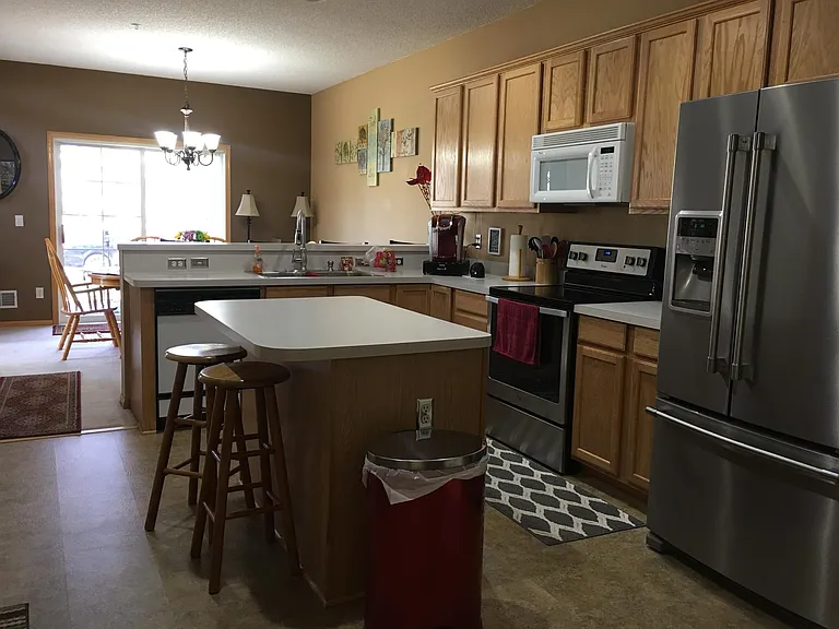 Stainless steel french door Maytag refrigerator and stove.