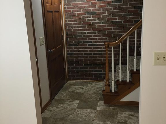Foyer Entry with coat close to left of front front door.