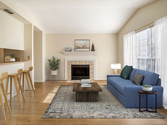 Renovated Package I kitchen and living area with hard surface flooring in common areas
