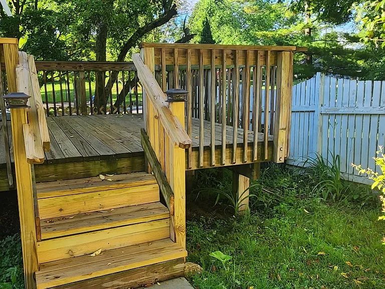 View of comfortable shared deck from back yard