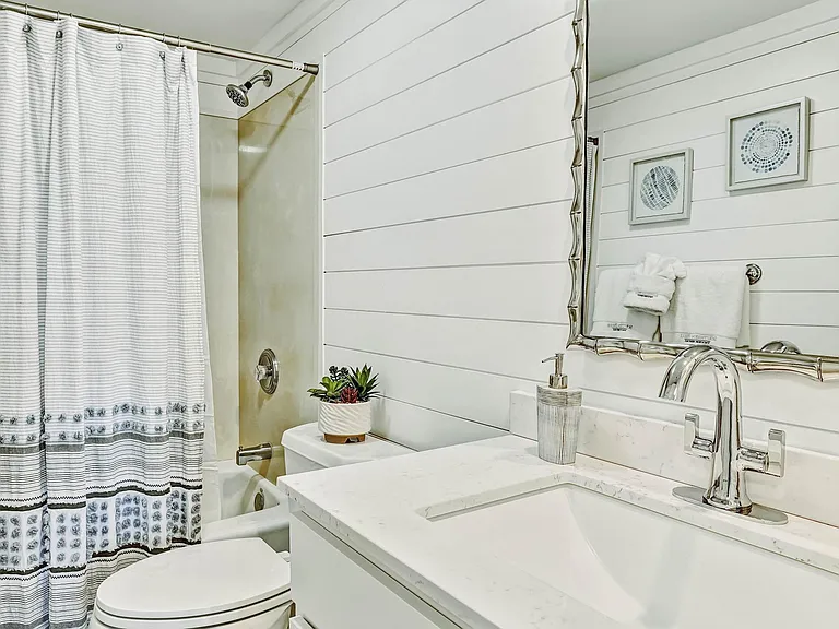 Full bathroom accessed from hall.