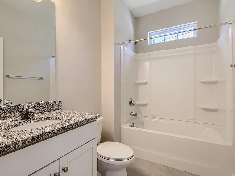 Shared bathroom with tub shower.