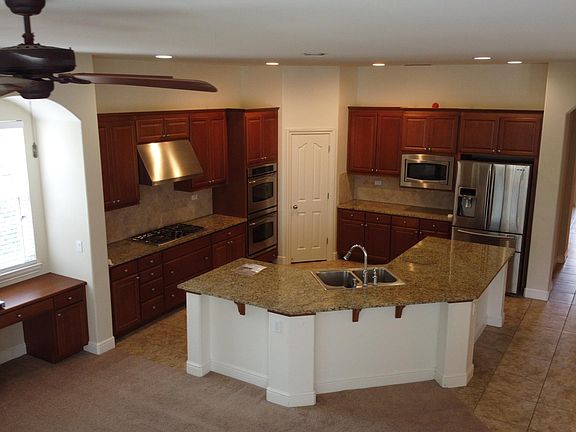 Big spacious kitchen with stainless steel appliances.