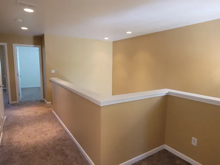 Looking out of the master bedroom back to the guest bedrooms. Alcove to the right could fit a desk or laundry baskets.