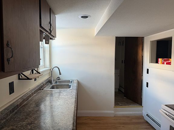 from the kitchen looking the other way into the bathroom