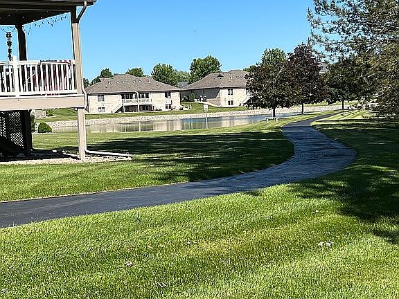 paved walking trail and pond