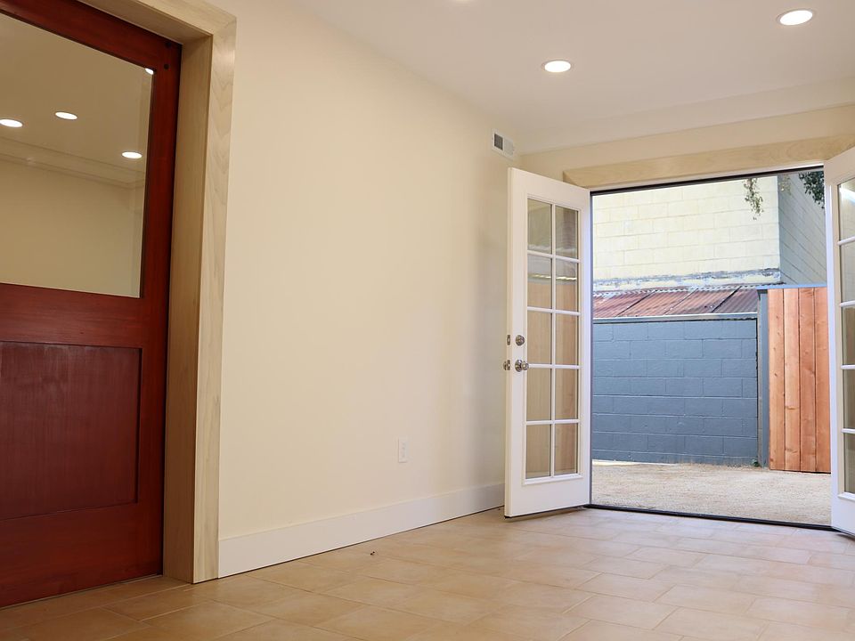 Main area with french doors to back yard and door to bedroom