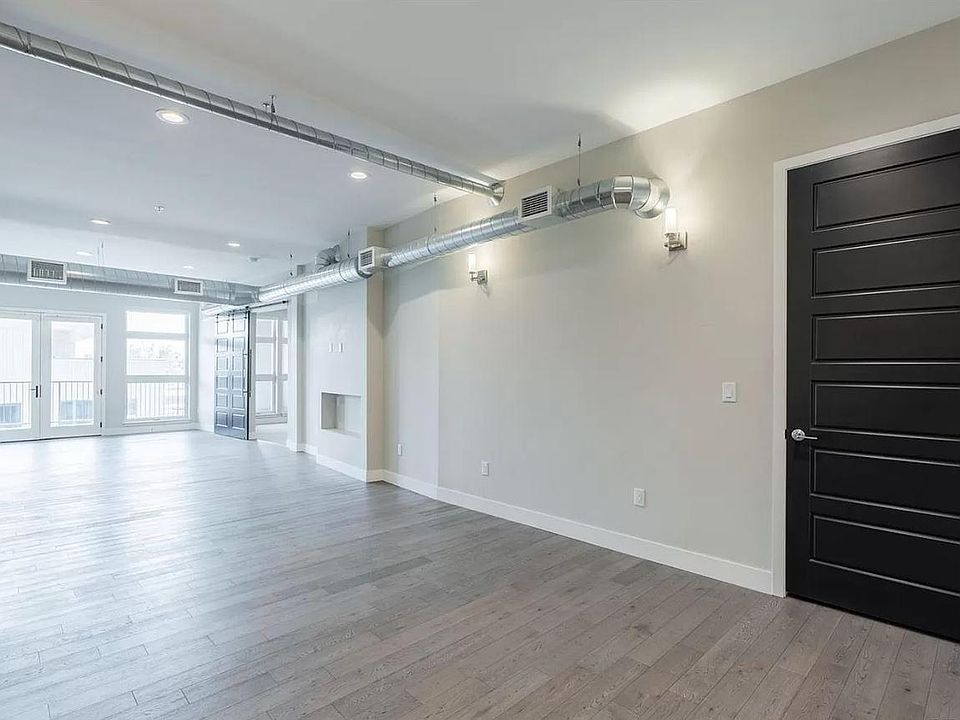 Enter into a modern and luxurious dining / living room with industrial exposed ducting