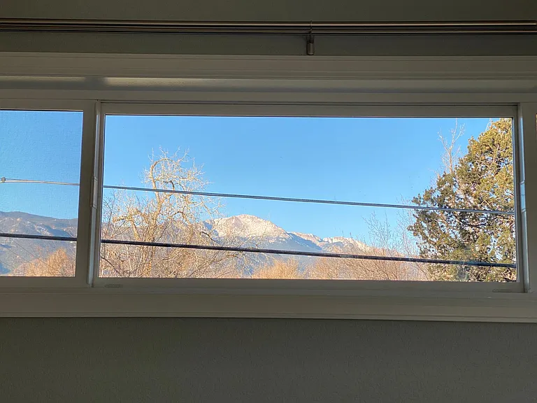 Large windows provide coveted views of Pikes Peak by day and downtown city lights by night.