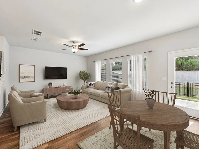 Living room with large window letting in a ton of natural light.