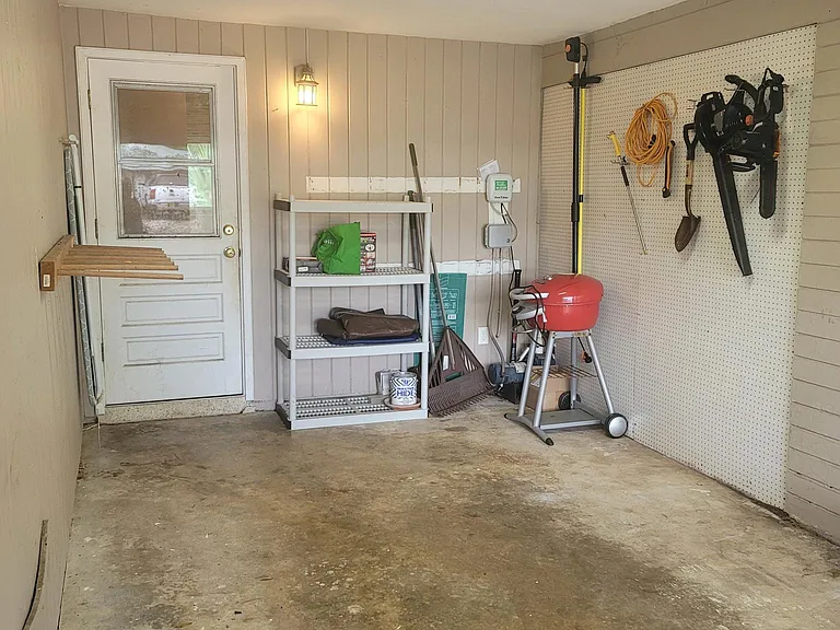 Single Car enclosed garage with wall storage, surfboard rack & attic space