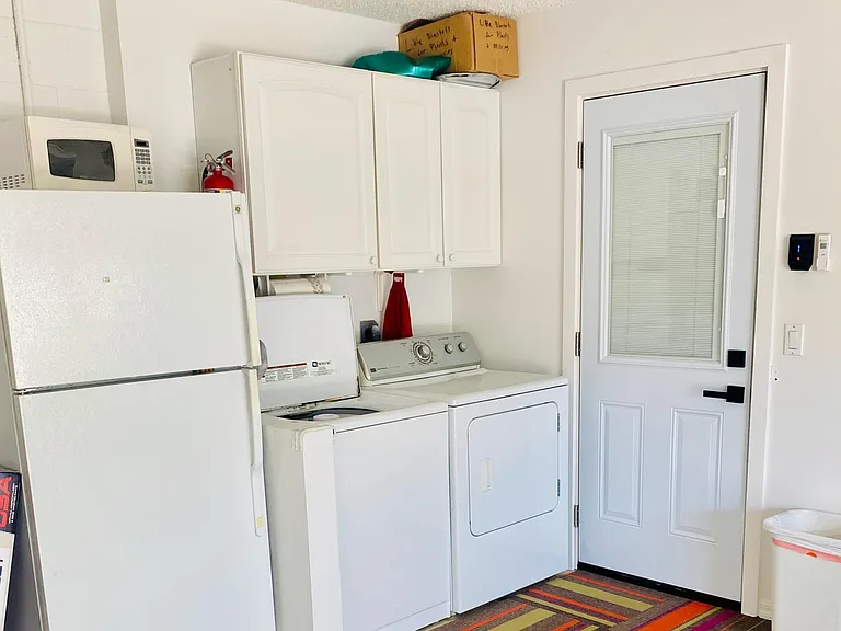 Extra Fridge, washer and dryer in garage area