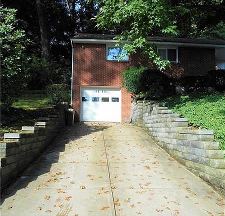 Newer retaining walls and concrete driveway make it easier to navigate in and out of your garage. Plenty of room here for additi