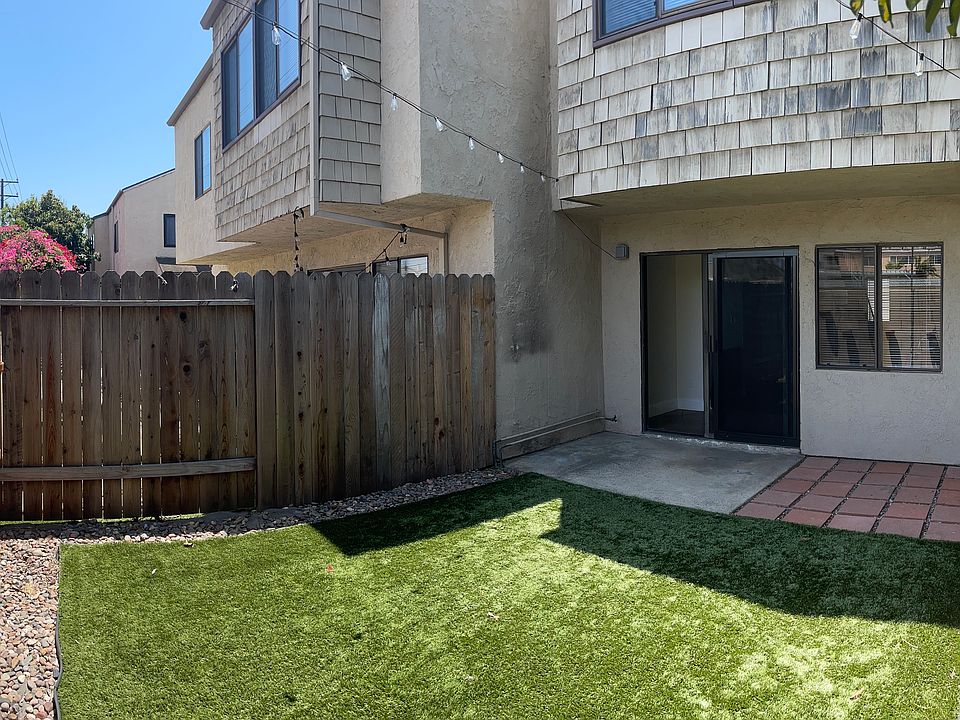 Sliding glass door in living space to private back yard with fake grass and overhead string lights.
Yard is 15'x20'.
