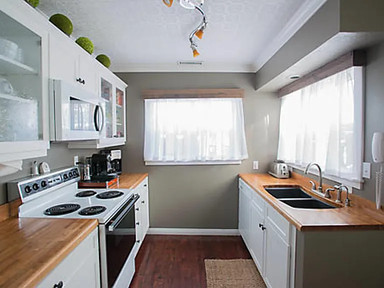 Kitchen with pots/pans, dishware and cooking supplies.