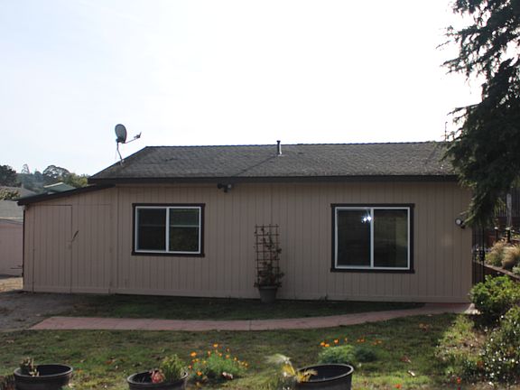 front of house, garage doors on left end of building