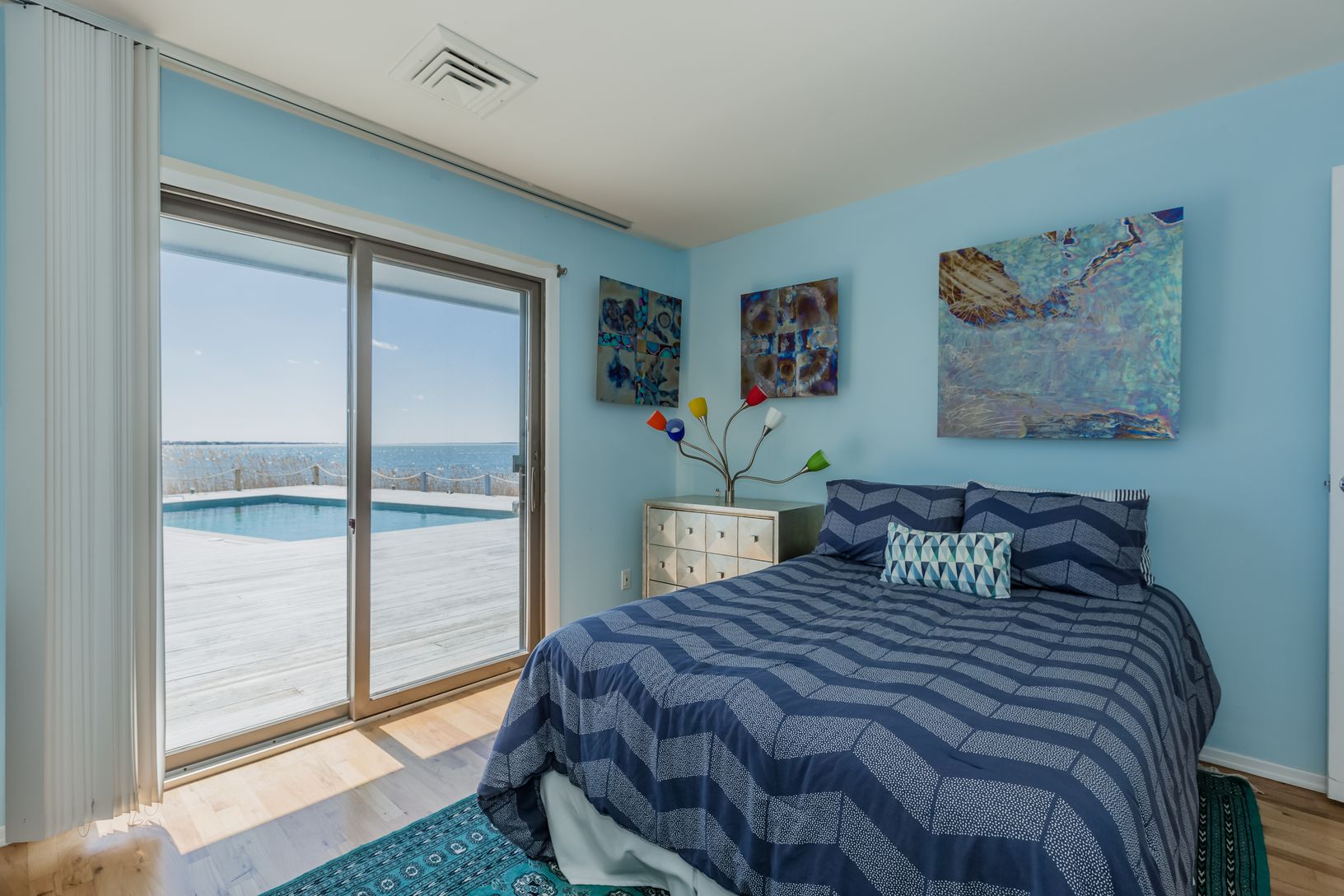 Guest room with fabulous waterfront views with sliders to the pool deck