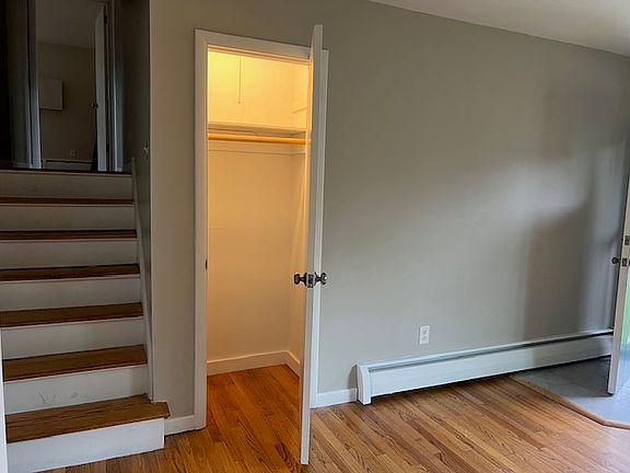 Living room closet and stairs to upper level