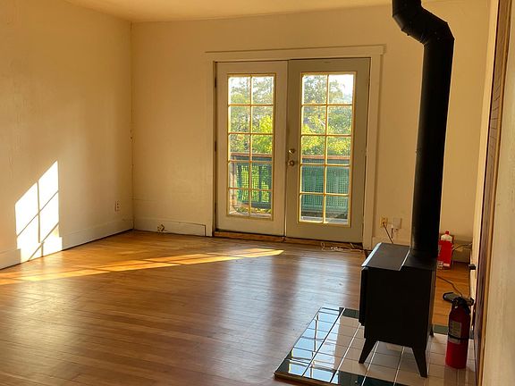 living room with fireplace and hardwood floors and French doors
