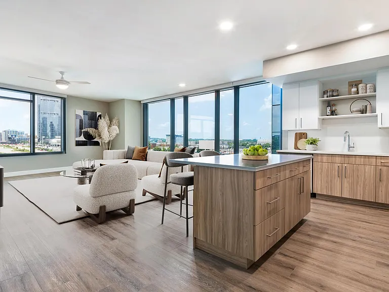Enjoy a modern kitchen with 42" soft-close cabinetry with under cabinet lighting, quartz counters, and open shelving for added function and style.