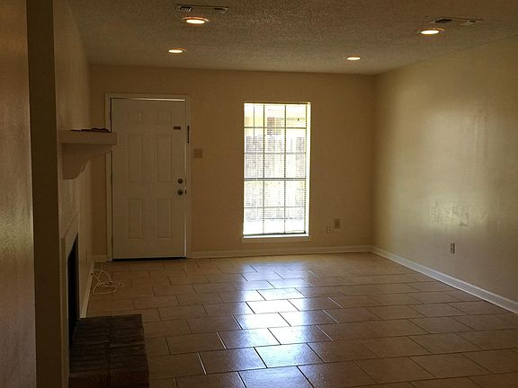 Another Angle of the entryway, living room and dining area