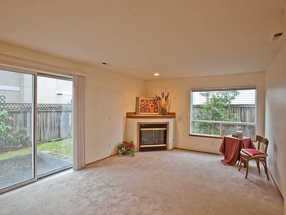 Living room with gas fireplace. Lots of light. Sliding door