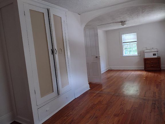 Bedroom 1, hard wood floors with 3 windows and closet.
