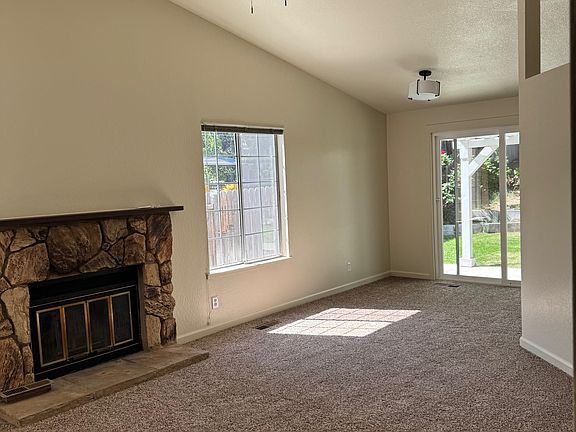 Living room, vaulted ceiling, fan, fireplace