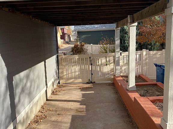 Covered carport for extra parking or outdoor dining area.
