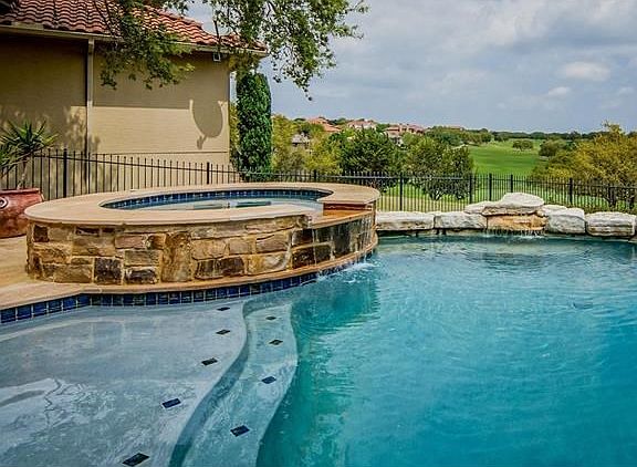 Pool and hot tub overlooking the view down the fairway.