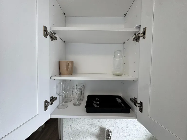 Kitchen cabinet storage with adjustable shelving for organizing dishes, glassware, and everyday essentials.