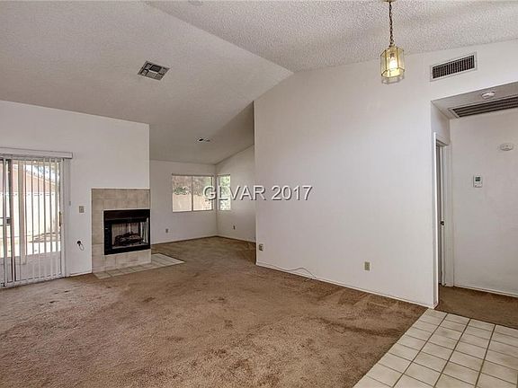 Living room has vaulted ceilings and fireplace