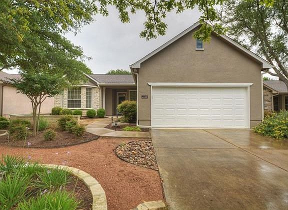 Custom Barringer landscaping adds charming curb appeal at this delightful one-owner Sun City Texas Dickinson.