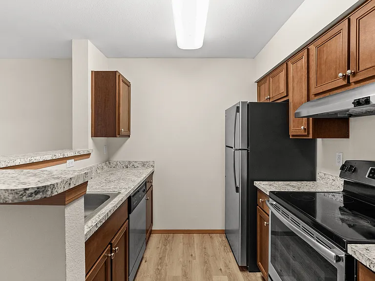 Modern kitchen with granite-style countertops, black appliances, and ample cabinet space_designed for functional living in Tacoma, WA. Modern kitchen with granite-style countertops, black appliances, and ample cabinet space_designed for functional living