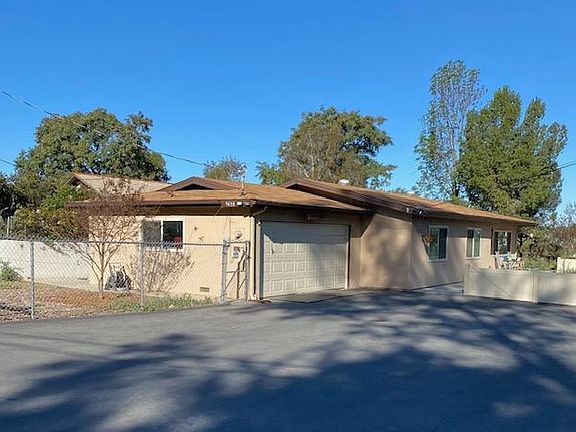 Covered patio on north side; enclosed yard on south and west sides.