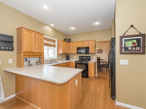 A practical kitchen with pantry and breakfast bar.