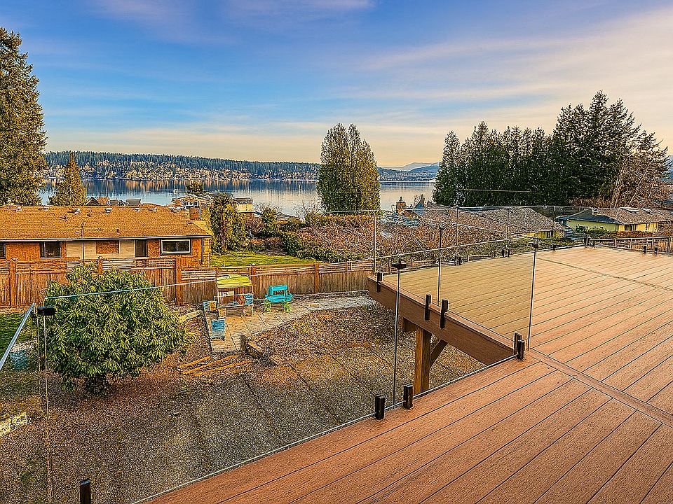 New comp deck with designer frameless glass railing with expansive lake sammamish view