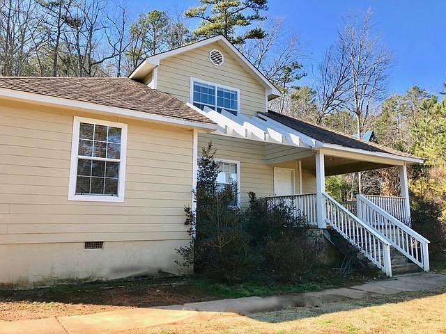 Front view showing the front porch with view of the lake acr